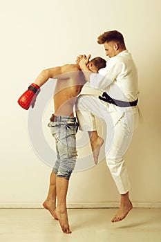 Sport and combat, karate athlete jumping, kicking knee at boxer