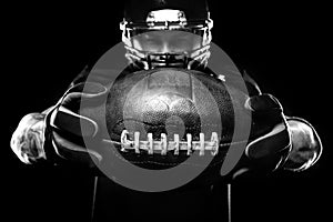 Sport concept. American football sportsman player on black background. Sport concept.