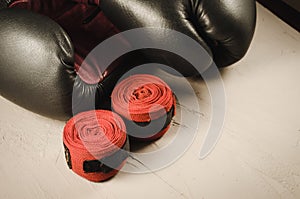 sport concept with gray boxing gloves and red bandage/sport concept with gray boxing gloves and red bandage on a stone background