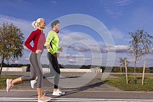 Sport Concepts. City Running Couple Happily Jogging Outside as Runners Training Outdoors Working Out in City As Fitness Couple
