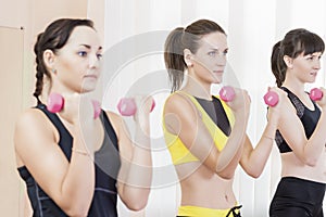 Sport Concepts. Three Caucasian Fit Women Performing Exercises