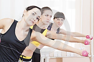 Sport Concepts. Three Caucasian Fit Women Performing Exercises