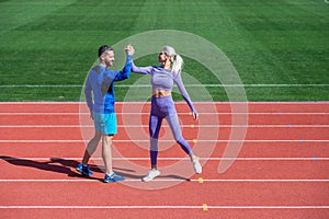 sport couple celebrate team win. fitness partners. athletic man and sexy woman compete in armwrestling. male and female