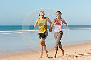 Sport couple jogging on the beach