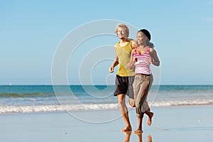 Sport couple jogging on the beach