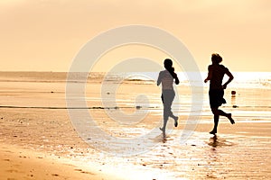 Sport couple jogging on the beach