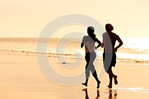 Sport couple jogging on the beach