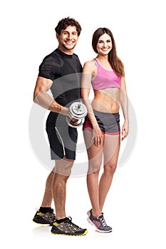 Sport couple - man and woman with dumbbells on the white