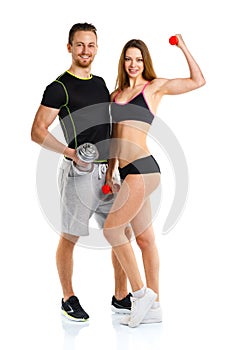Sport couple - man and woman with dumbbells on the white