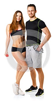 Sport couple - man and woman with dumbbells on the white