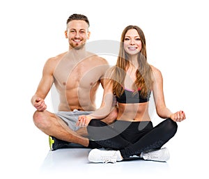 Sport couple - man and woman after fitness exercise sitting with