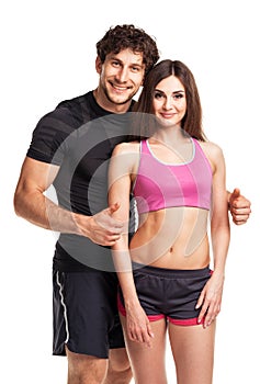 Sport couple - man and woman after fitness exercise on the white