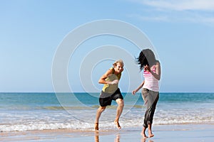 Sport couple playing on the beach