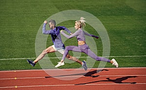 sport couple run fast to win. fitness sprinters. athletic man and sexy woman compete in sprint