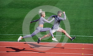 sport couple run fast to win. fitness sprinters. athletic man and sexy woman compete in sprint