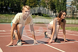 Sport couple start competition running at arena track