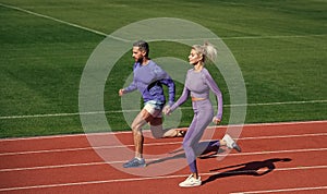 sport couple team in sportswear running on stadium, competition
