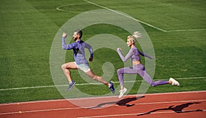 sport couple team in sportswear running on stadium, stamina