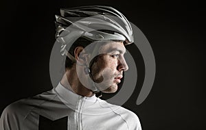 Sport. Cyclist carry a bike on black background.