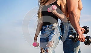 Sport, dumbbell, fitness, couple sports. Sportive woman and man, team. Sporty couple showing muscle and workout