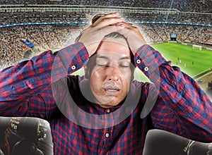 Sport emotion conceptual portrait of nervous and dejected soccer supporter man and football pitch background gesturing desperate