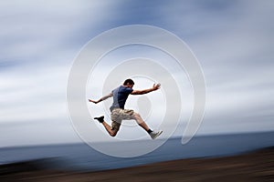 Sport and energy concept - man running fast photo