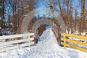 Sport enthusiasts paved a skiing trail through pedestrian bridge in snow.