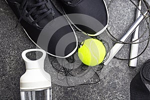 Sport equipment and black sneakers on concrete background