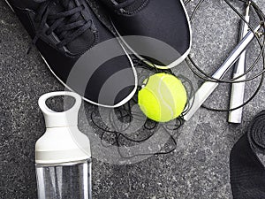 Sport equipment and black sneakers on concrete background