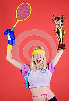 Sport equipment store. Sport shop assortment. Girl cheerful successful modern woman hold golden goblet of sport champion