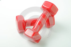 Sport equipment. Two red dumbbells for fitness weighing 2 kg on a white background