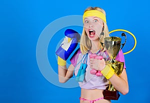 Sport for every day. Sport shop assortment. Girl successful modern woman hold golden goblet of sport champion and