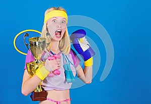 Sport for every day. Sport shop assortment. Girl successful modern woman hold golden goblet of sport champion and