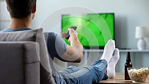 Sport fan watching recording of missed soccer match, modern smart tv technology