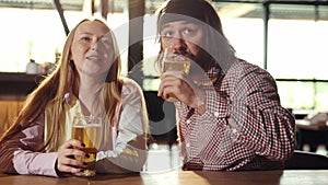 Sport fans, friends sitting at pub, bar, watching online football match translation, drinking beer. Double date