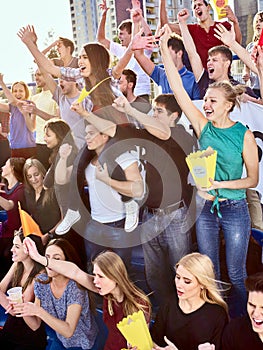 Sport fans holding champion banner on tribunes