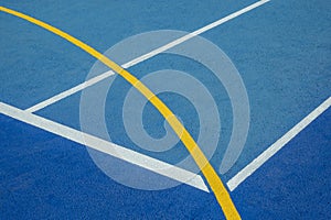 Sport field court background. Blue rubberized and granulated ground surface with white, yellow lines on ground. Top view