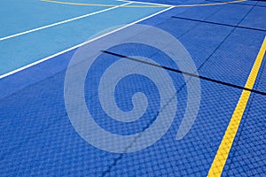 Sport field court background. Blue rubberized and granulated ground surface with white, yellow lines and tennis net