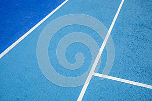 Sport field court background. Light blue rubberized and granulated ground surface with white lines. Top view