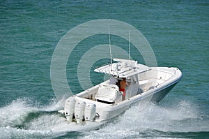 Sport fishing boat speeding across Biscayne Bay off Miami Beach,Florida photo