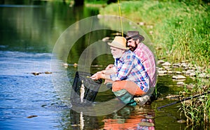 Sport fishing. Catching and fishing. Two male friends fishing together. fly fish hobby of men in checkered shirt