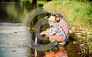 Sport fishing. Catching and fishing. Two male friends fishing together. fly fish hobby of men in checkered shirt