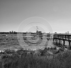 Sport fishing yacht passes by the docks