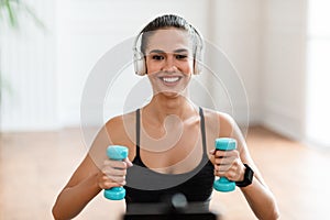 Happy Sporty Woman Exercising With Two Dumbbells And Posing
