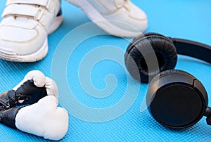 Sport fitness concept, space for text, black sneakers, blue dumbbells, headphones, fitness jump rope template