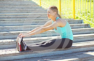 Sport, fitness concept - young woman doing stretching exercises