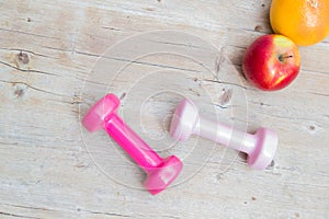 Sport fitness diet concept weights dumbbell and fruit