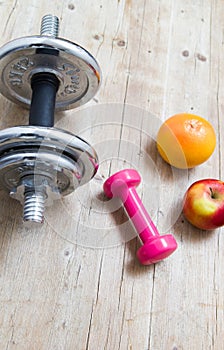 Sport fitness diet concept weights dumbbell and fruit