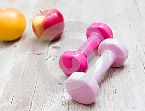 Sport fitness diet concept weights dumbbell and fruit