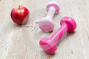 Sport fitness diet concept weights dumbbell and fruit